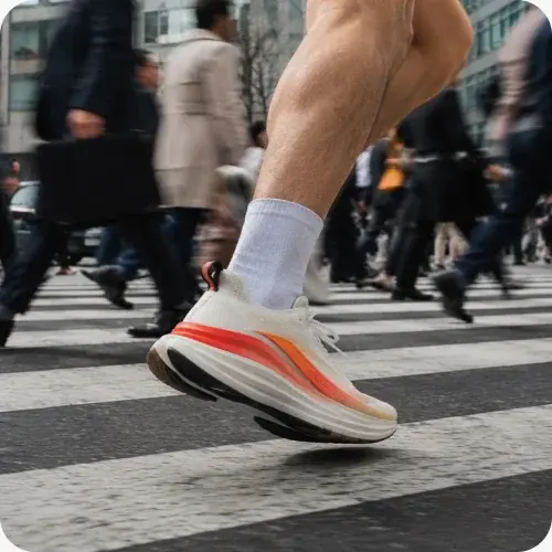 A runner crossing a busy city street in the product being tested