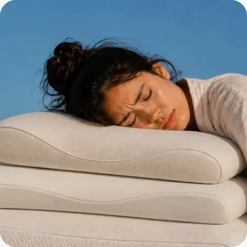 A participant resting on a stack of pillows she is testing